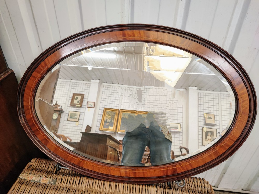 Antique inlaid mahogany oval mirror.
