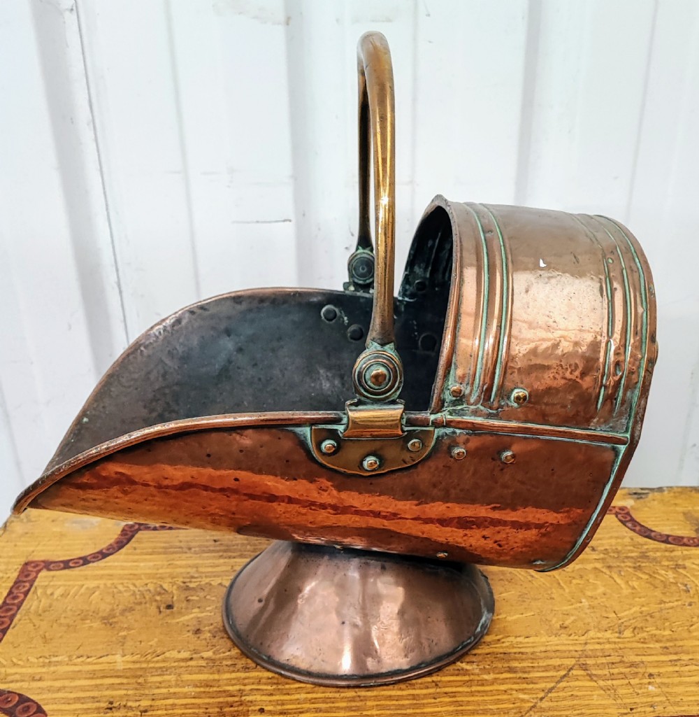 A Victorian copper and brass coal helmet.