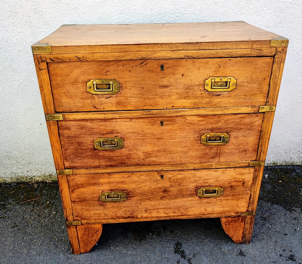 A small antique fruitwood military chest.