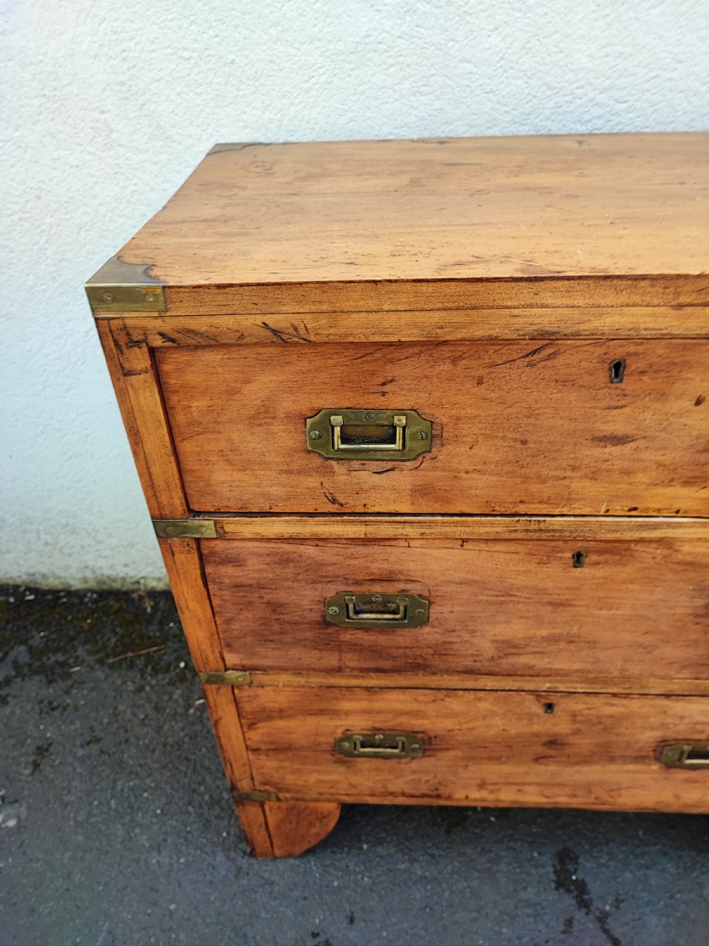 A small antique fruitwood military chest. View III