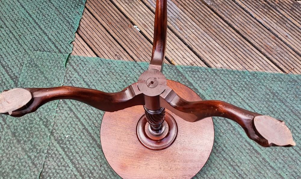 An antique George III style mahogany wine table featuring a spindle gallery rim, a turned spiral twist stem, and carved tripod cabriole legs with claw and ball feet. View III