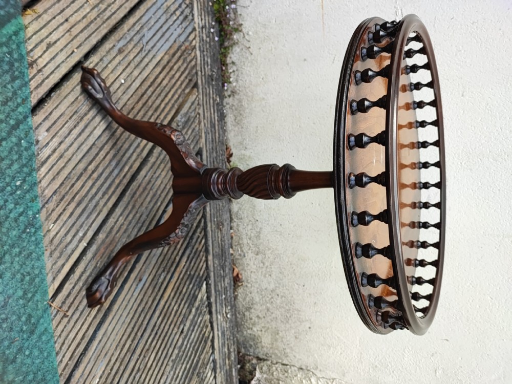 An antique George III style mahogany wine table featuring a spindle gallery rim, a turned spiral twist stem, and carved tripod cabriole legs with claw and ball feet. View V