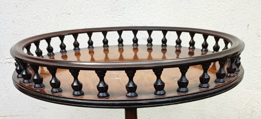 An antique George III style mahogany wine table featuring a spindle gallery rim, a turned spiral twist stem, and carved tripod cabriole legs with claw and ball feet. View VI