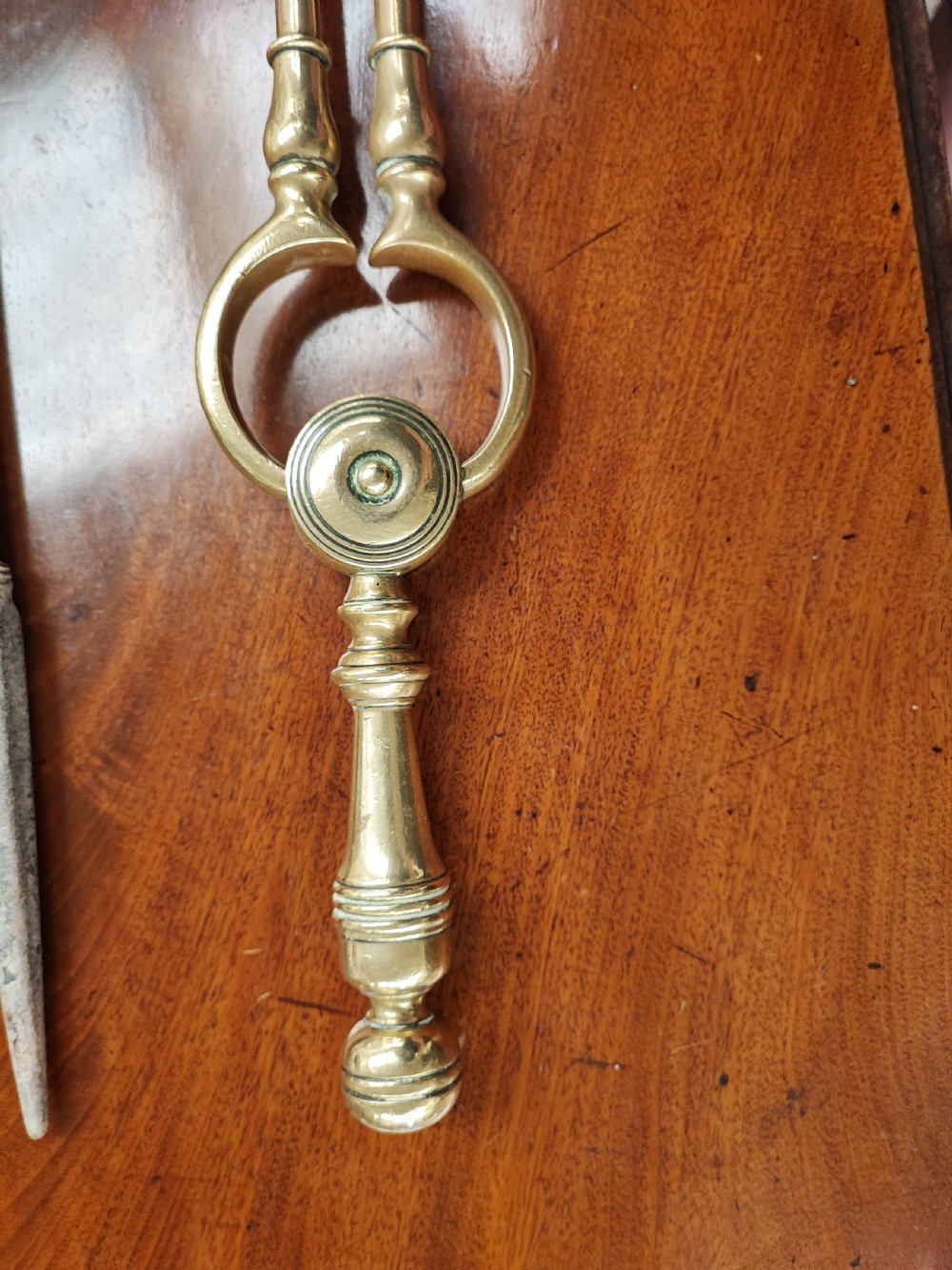 An antique of 3 brass fire irons of good quality. View V