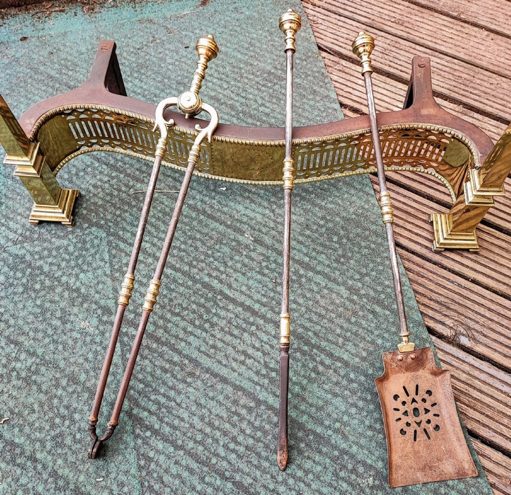 A superb antique serpentine fender and a set of 3 brass and iron fire irons. View II