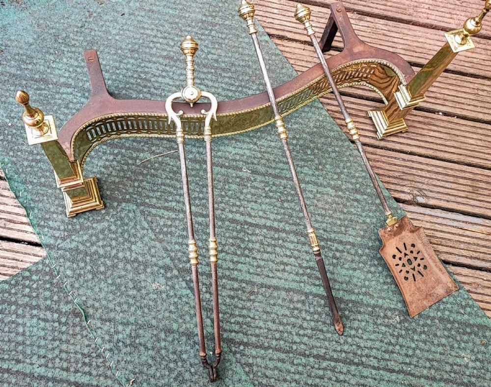 A superb antique serpentine fender and a set of 3 brass and iron fire irons. View XII