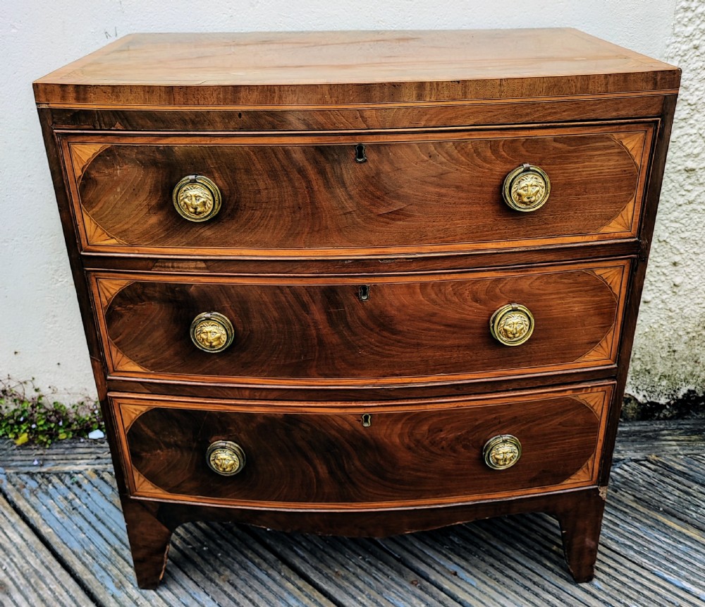 Regency mahogany inlaid bow front chest of drawers.