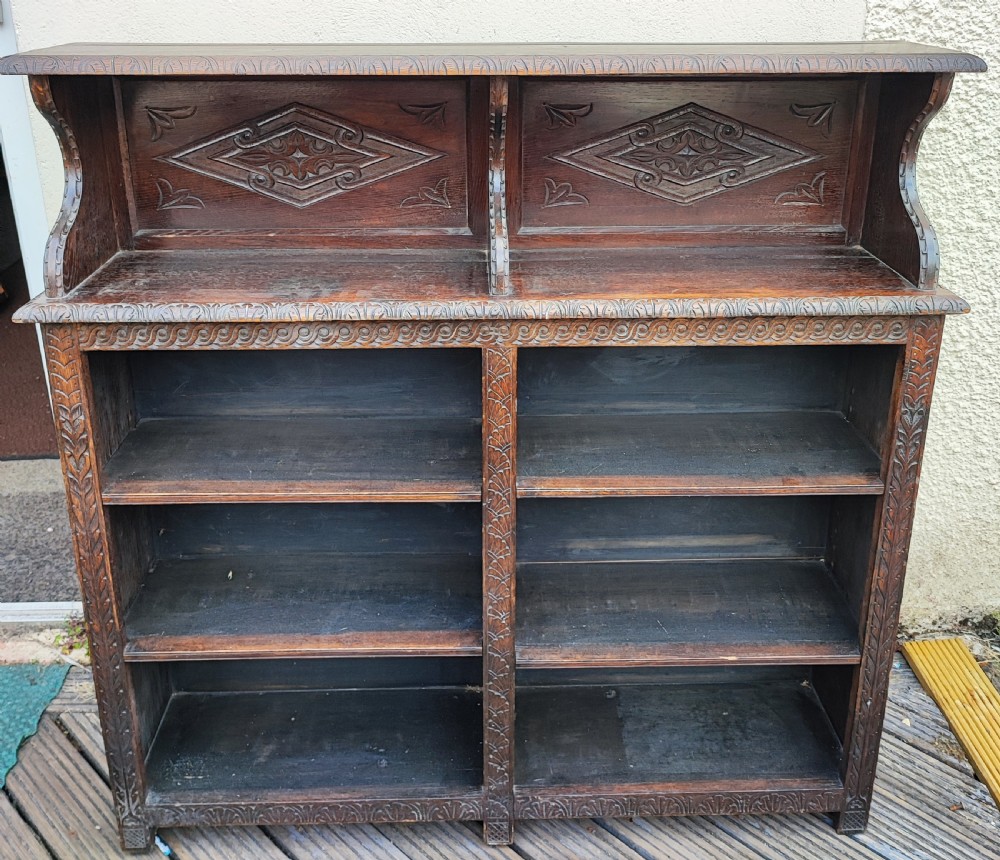 Antique carved oak open bookcase.