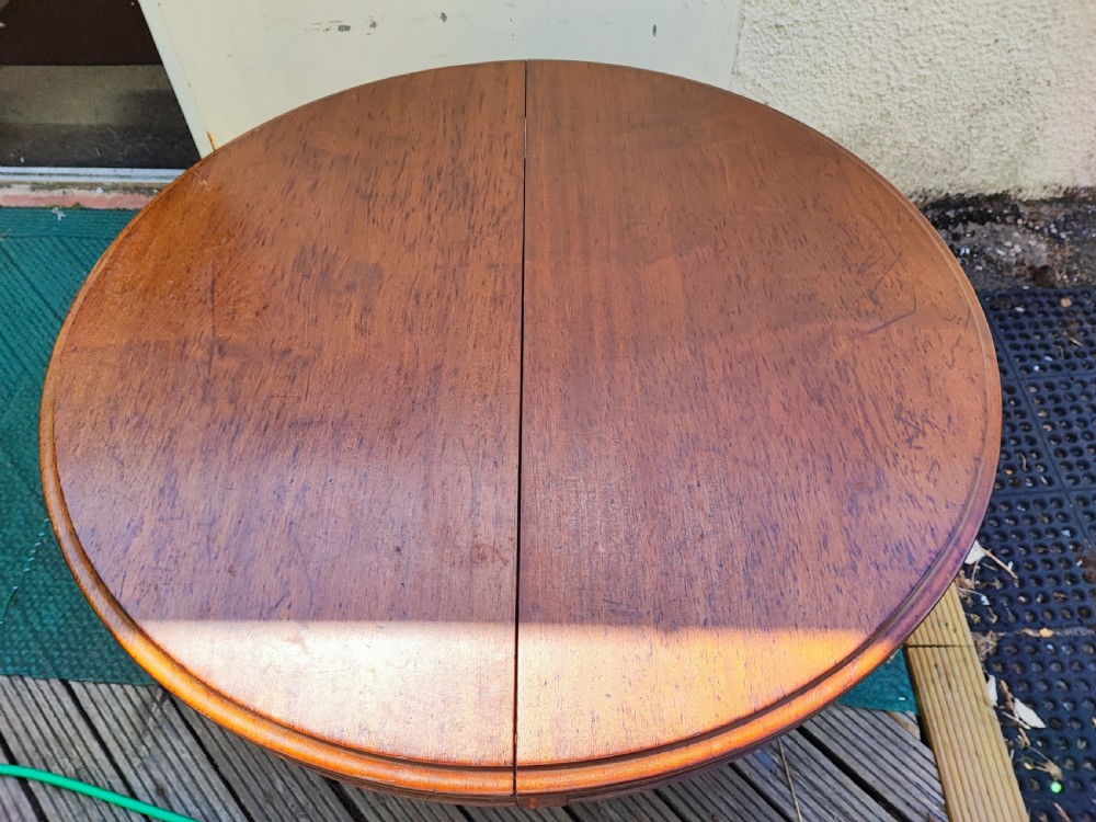 Antique mahogany circular extending dining table. View II