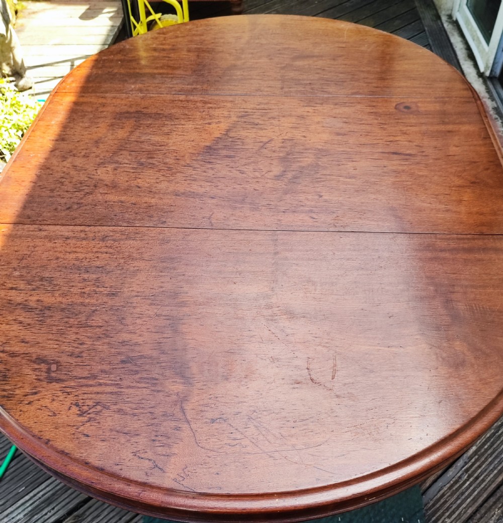 Antique mahogany circular extending dining table. View III