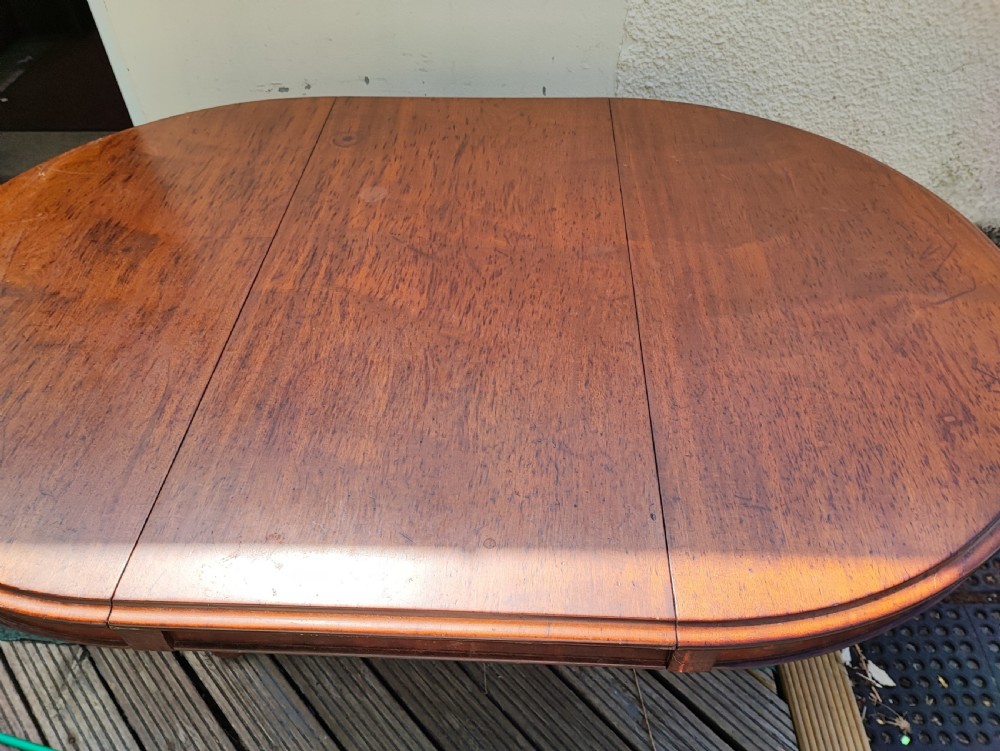 Antique mahogany circular extending dining table. View IV