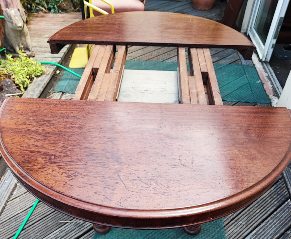 Antique mahogany circular extending dining table. View VII