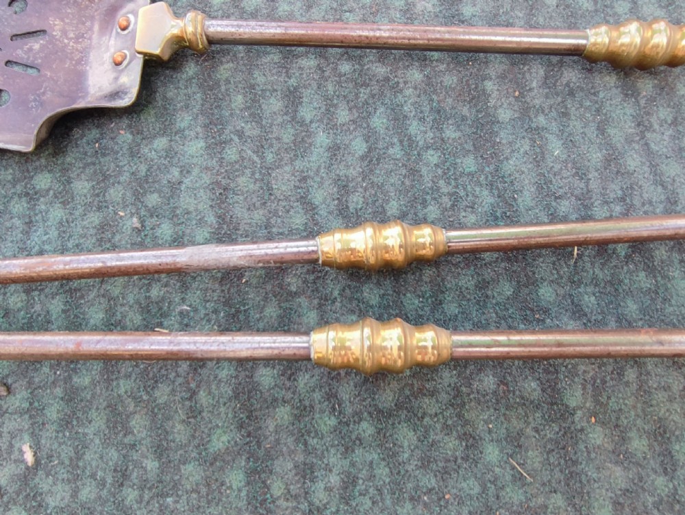 A superb set of antique brass and iron fire irons. View II
