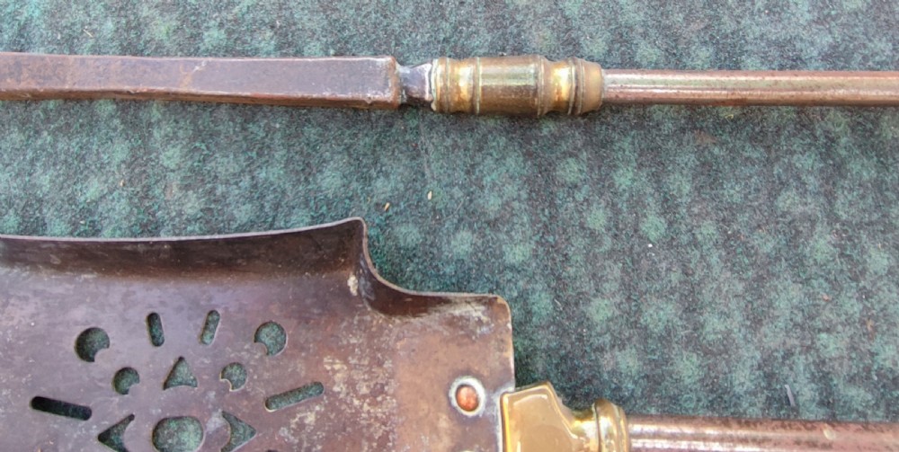 A superb set of antique brass and iron fire irons. View V