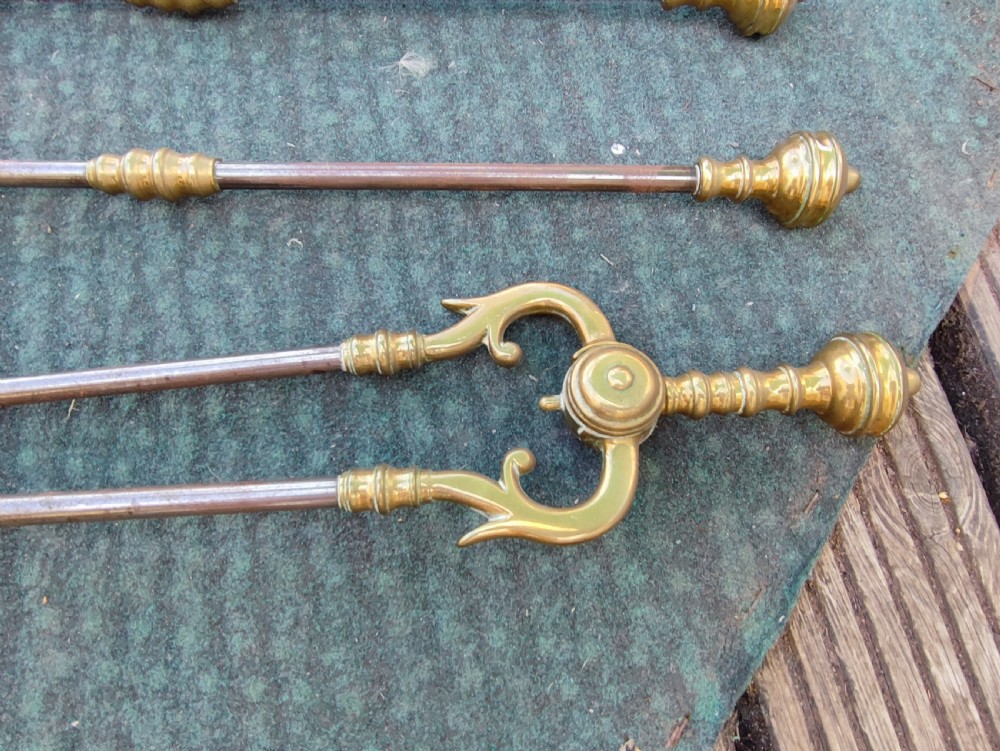A superb set of antique brass and iron fire irons. View VII