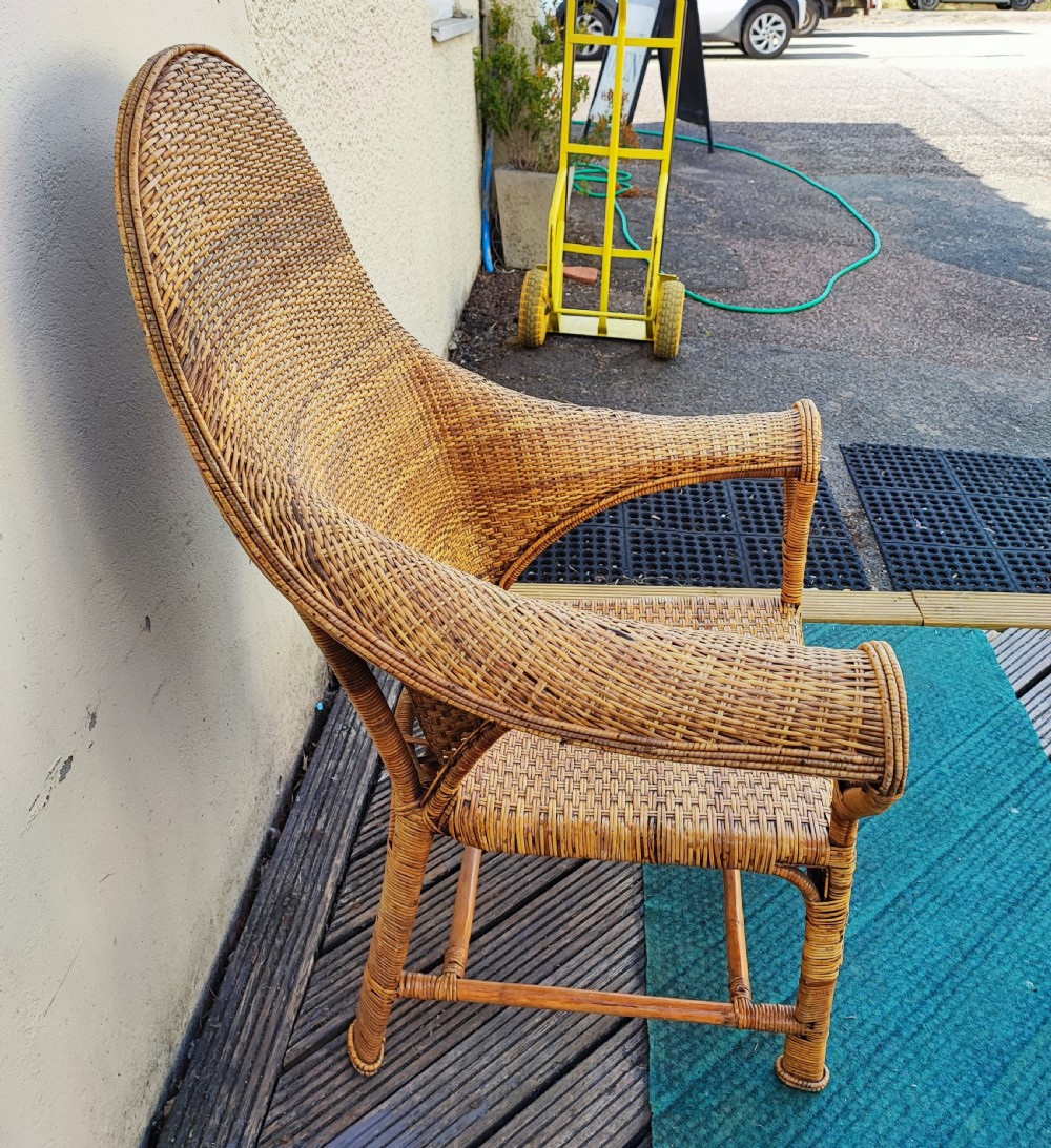 A 1920s Dryad art's and crafts cane armchair. View VI