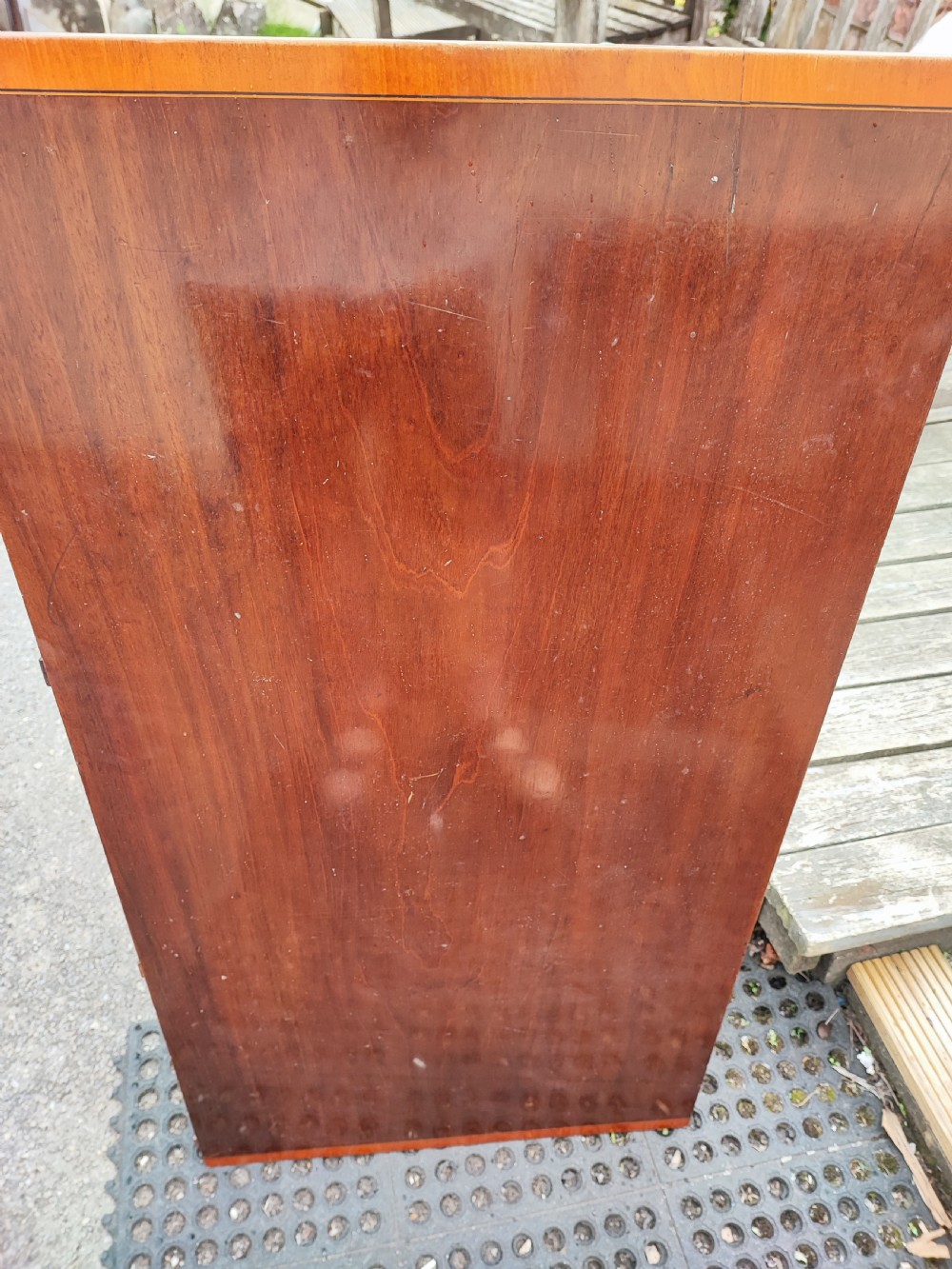 An oval Georgian style mahogany extendable dining table featuring a polished surface with crossbanded border detailing and four tapered square legs. View IX
