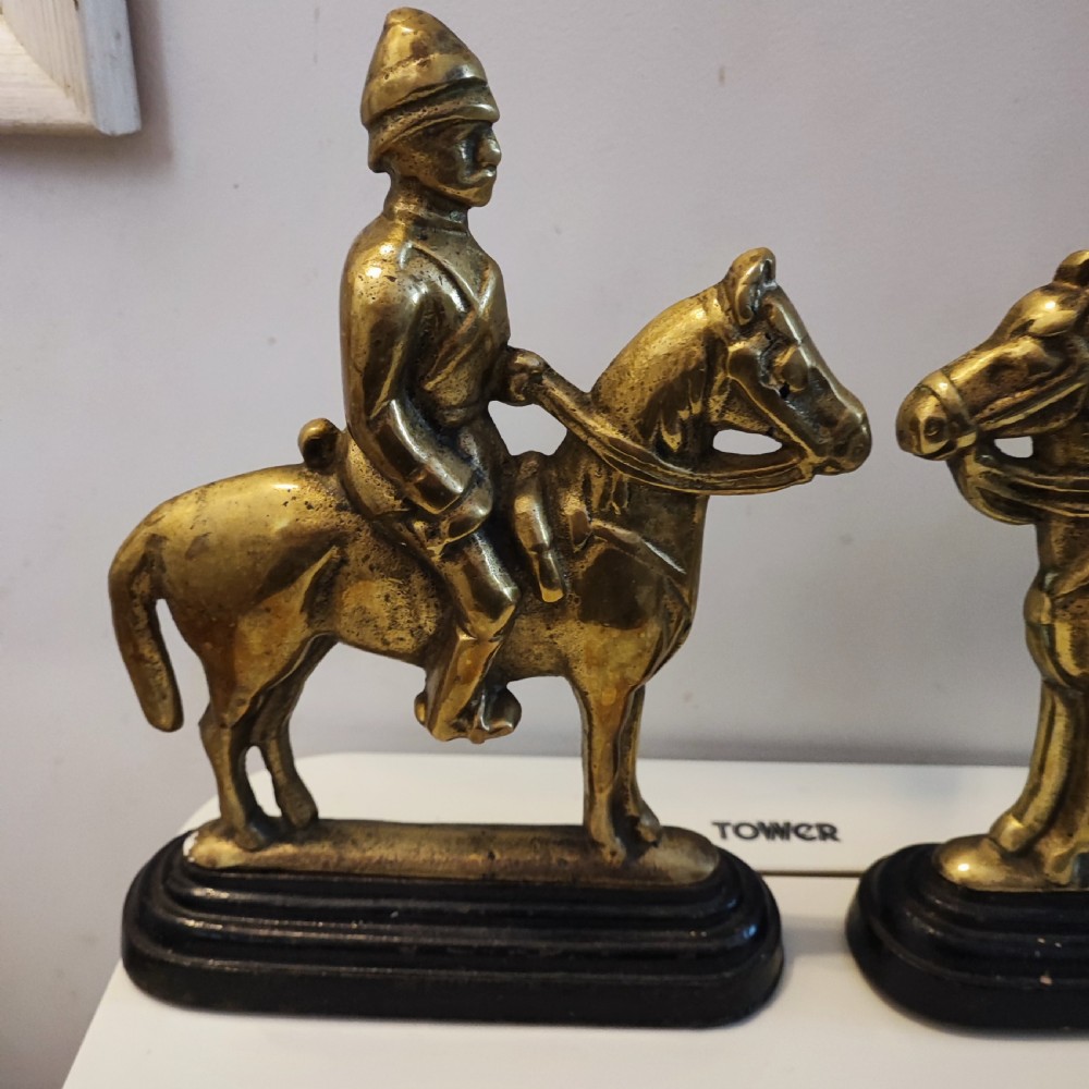 Antique pair of brass military door stops View V