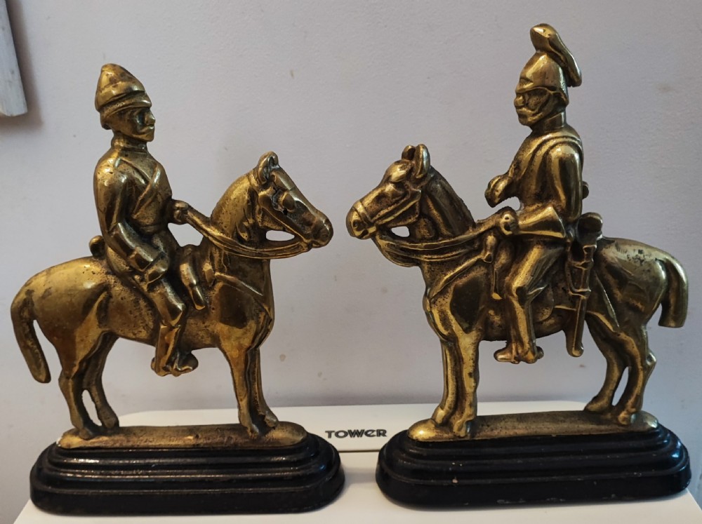 Antique pair of brass military door stops View VI