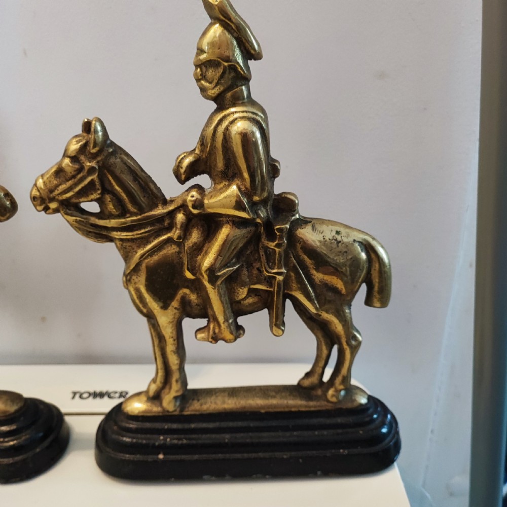 Antique pair of brass military door stops View IX