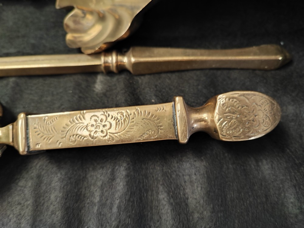A set of three antique solid brass fire irons comprising a poker, tongs, and a shovel with a decorative shell pan. View IV