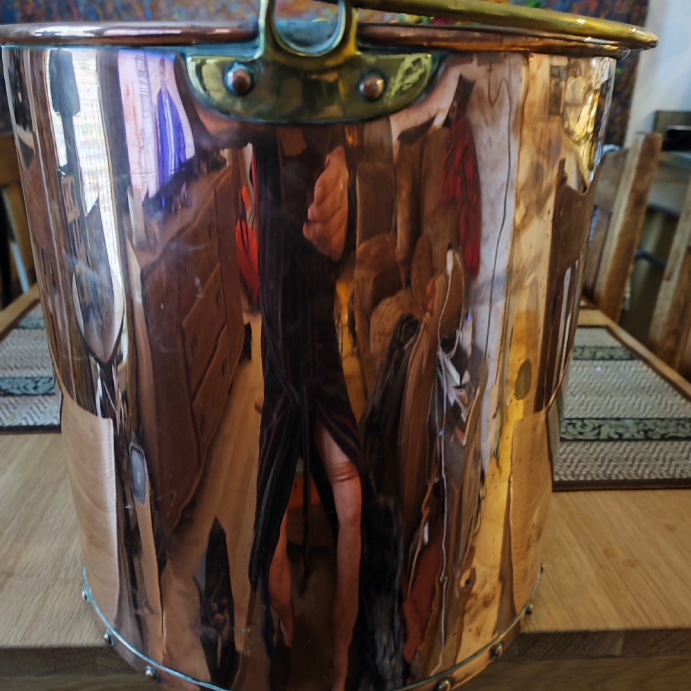 A cylindrical polished copper bucket featuring a riveted vertical seam, a rolled brass rim, and a band of rivets around the base. View III