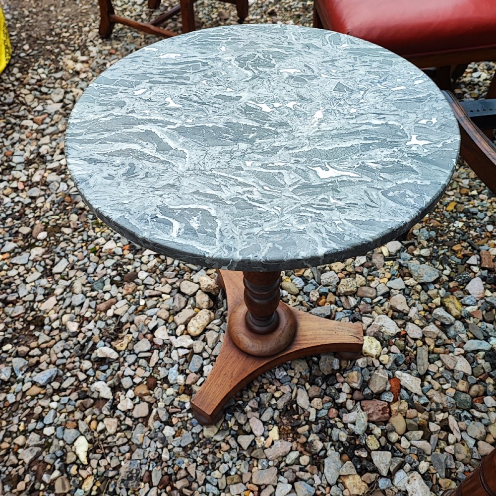 A circular grey variegated marble top side table featuring a turned wooden pedestal column and a tri-form base. View VI