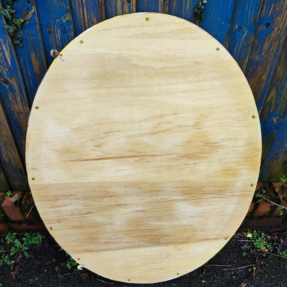 A large gold gilt oval wall mirror featuring a rope twist outer moulding and segmented glass border surrounding an inner oval mirror pane. View IV