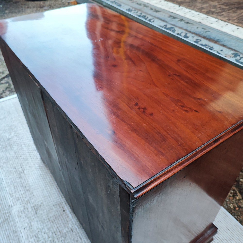 A Georgian mahogany chest of drawers with two short drawers over three long graduated drawers, finished with brass swan-neck handles and bracket feet. View IV