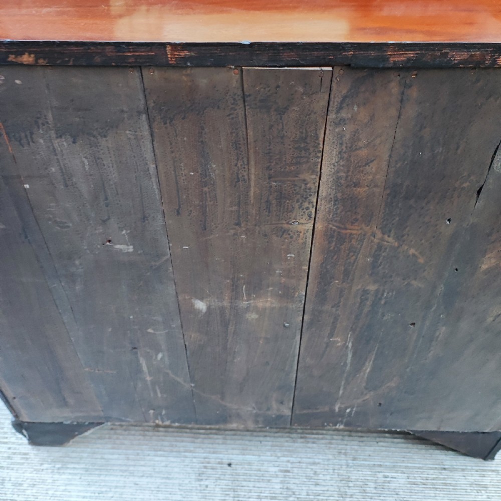 A Georgian mahogany chest of drawers with two short drawers over three long graduated drawers, finished with brass swan-neck handles and bracket feet. View VII