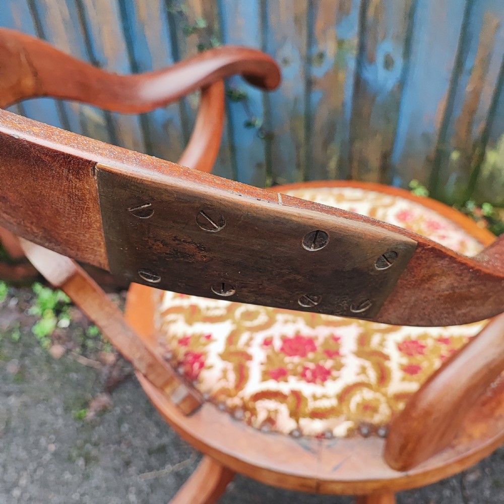 A Victorian mahogany revolving desk chair featuring a curved horseshoe armrest, a pierced central back splat, and an upholstered circular seat. View VI