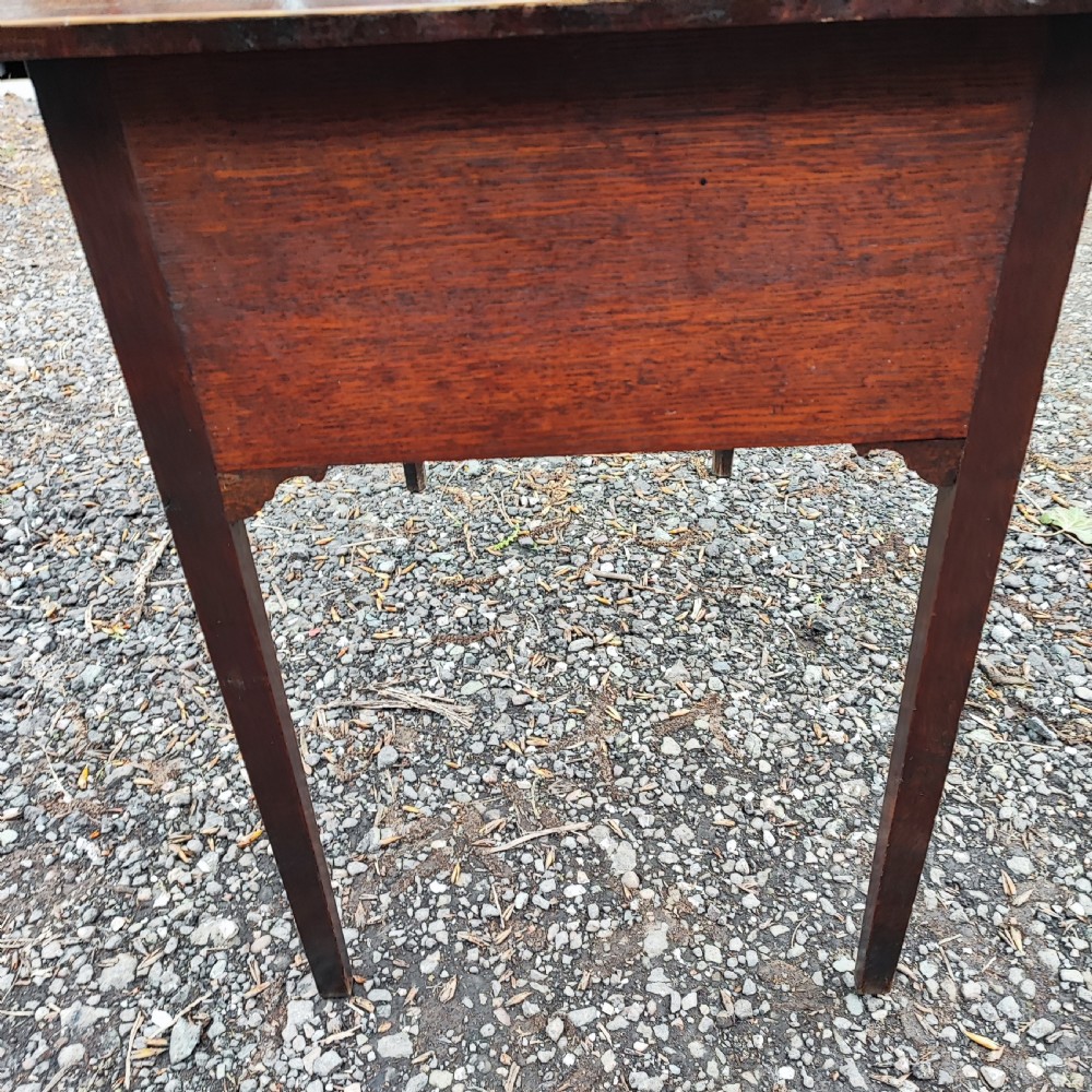 A Georgian dark oak lowboy side table featuring a rectangular top, three drawers with brass handles, inlaid stringing, corner spandrels, and straight tapering legs. View VIII