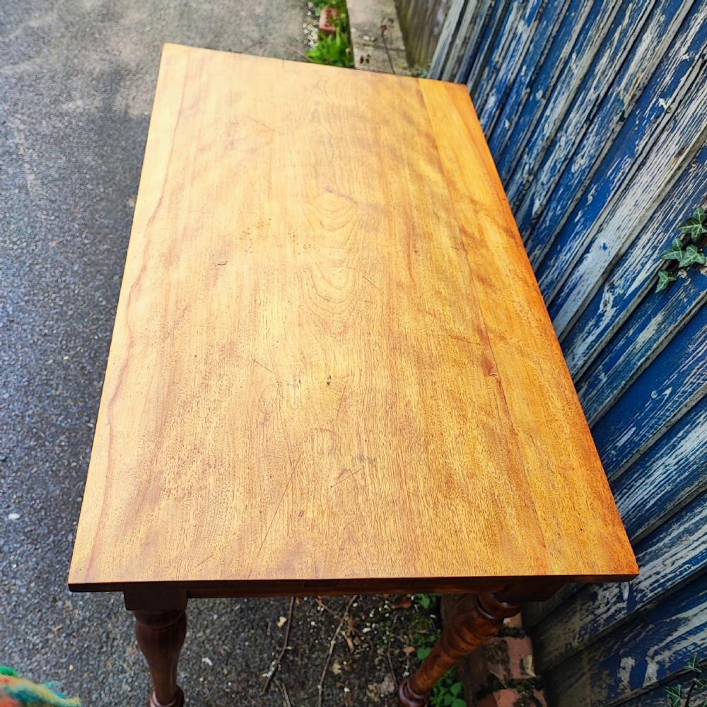 A golden satinwood side writing table featuring two frieze drawers with turned handles and four turned tapered legs. View II