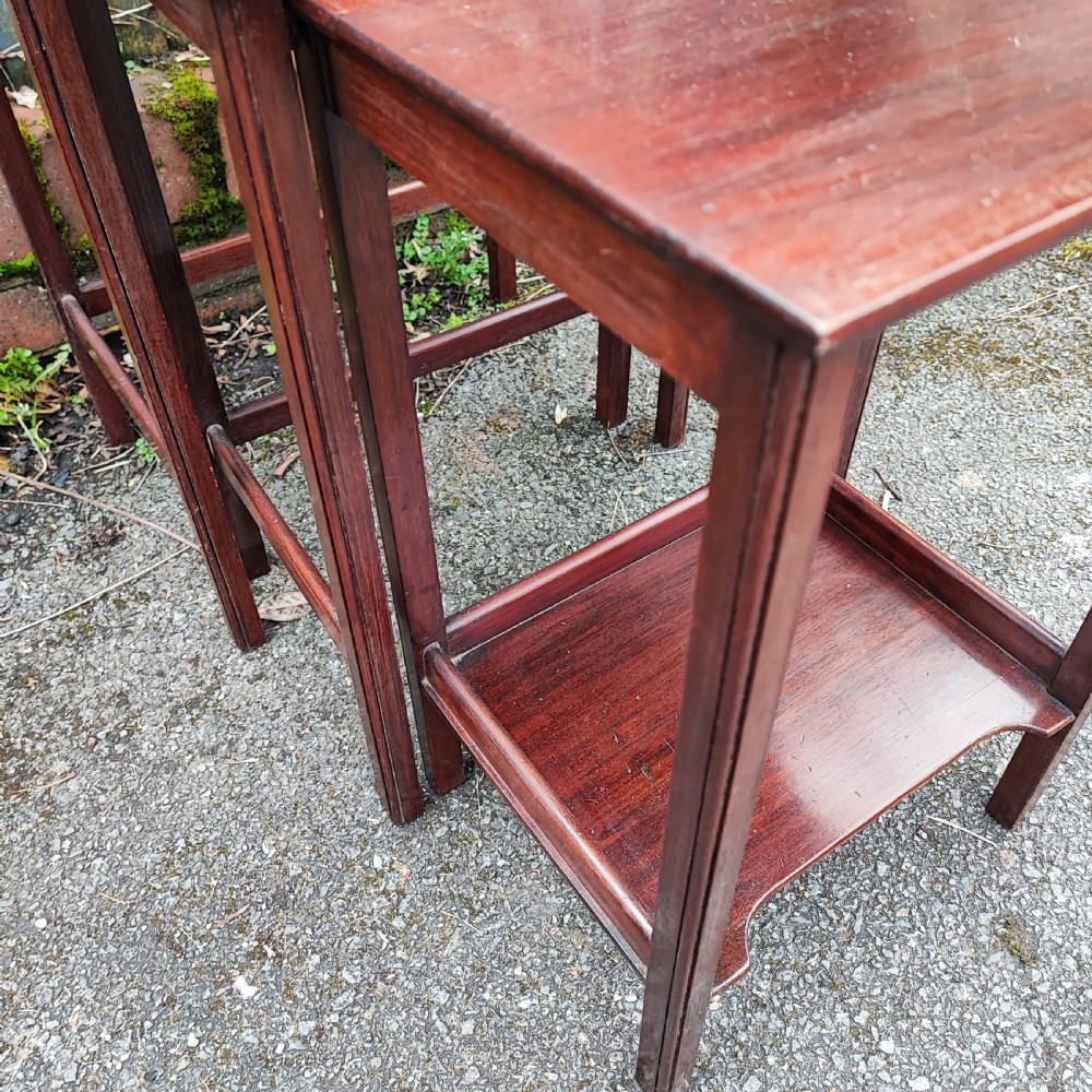 A set of three graduated Edwardian mahogany nesting tables with rectangular tops and slender square legs. View III
