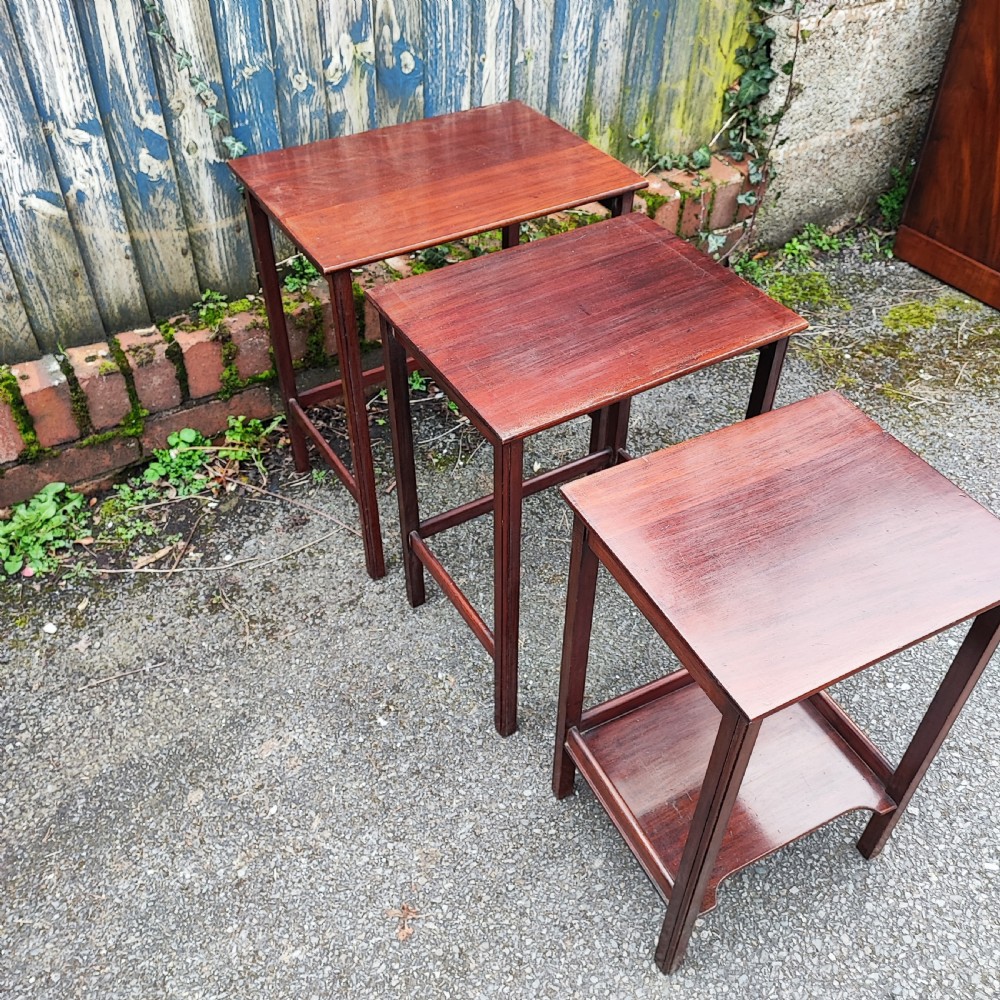 A set of three graduated Edwardian mahogany nesting tables with rectangular tops and slender square legs. View IV