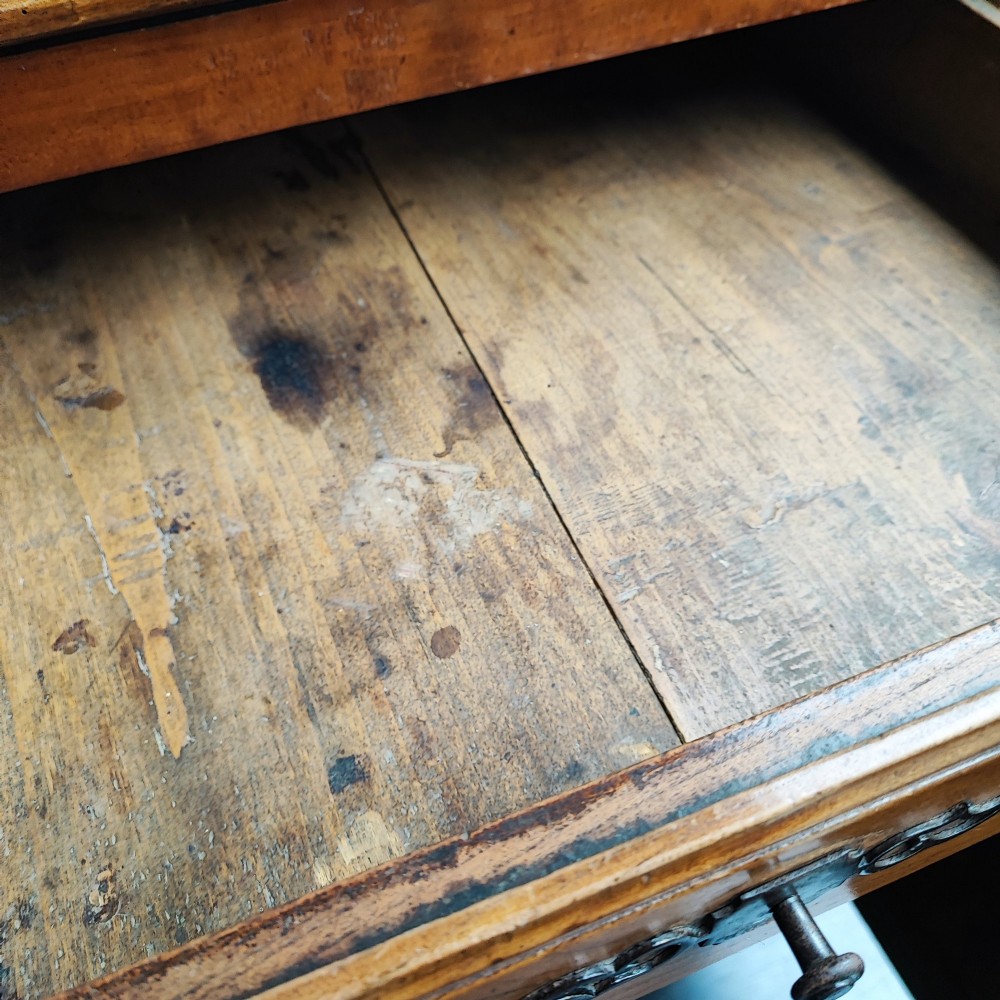 An 18th century French cherry wood side cabinet featuring two drawers above two carved panel doors with ornate metal escutcheons and cabriole feet. View III
