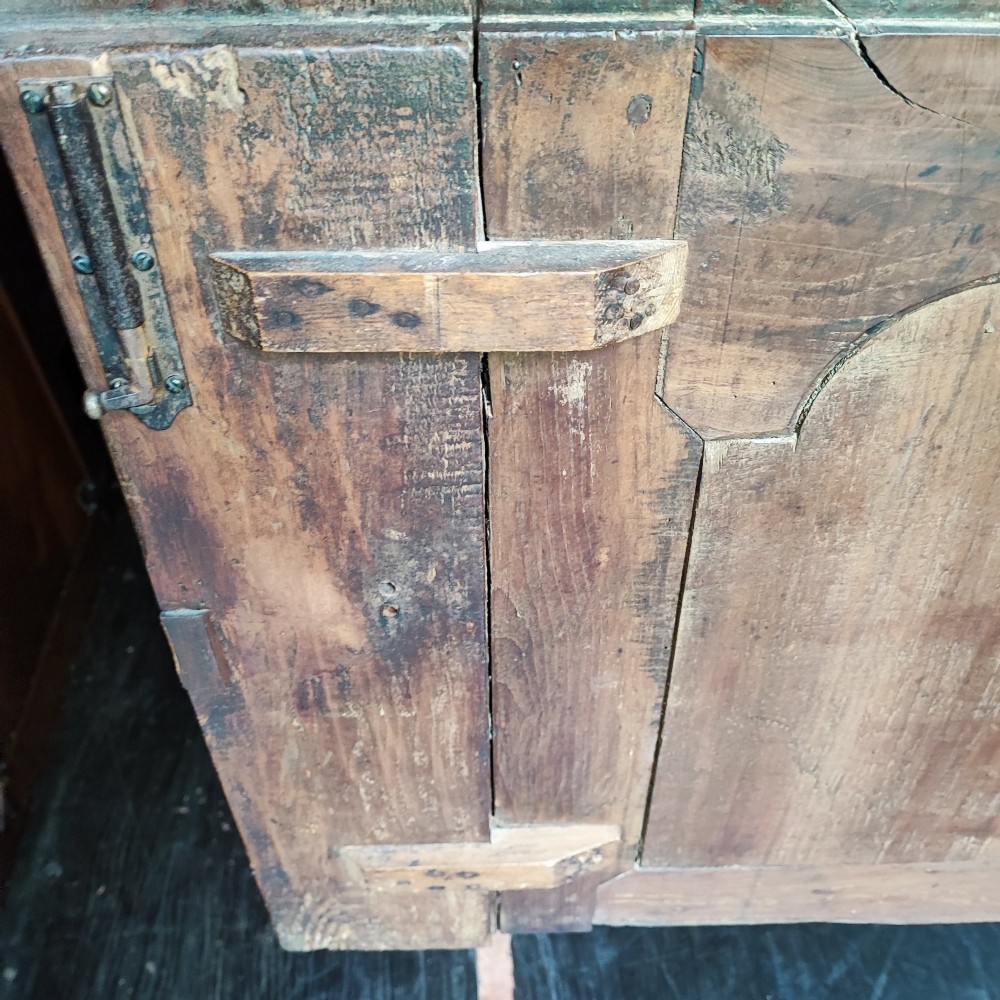 An 18th century French cherry wood side cabinet featuring two drawers above two carved panel doors with ornate metal escutcheons and cabriole feet. View V
