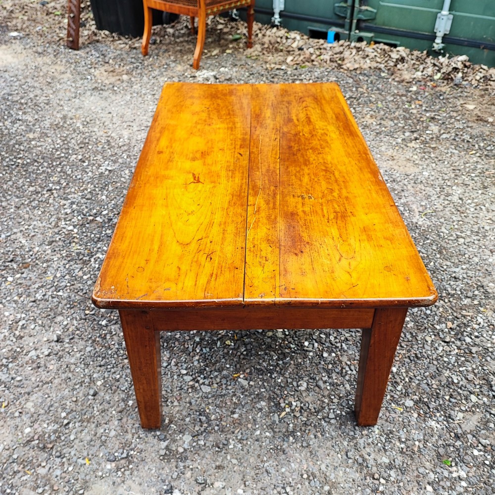 An antique French cherrywood rectangular coffee table with a warm golden-amber surface and square straight legs. View II