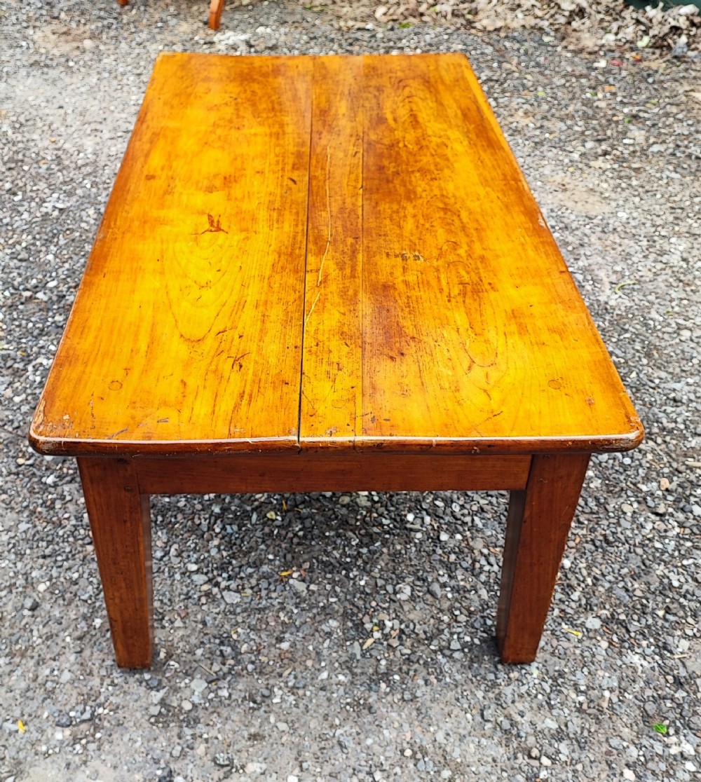 An antique French cherrywood rectangular coffee table with a warm golden-amber surface and square straight legs. View V