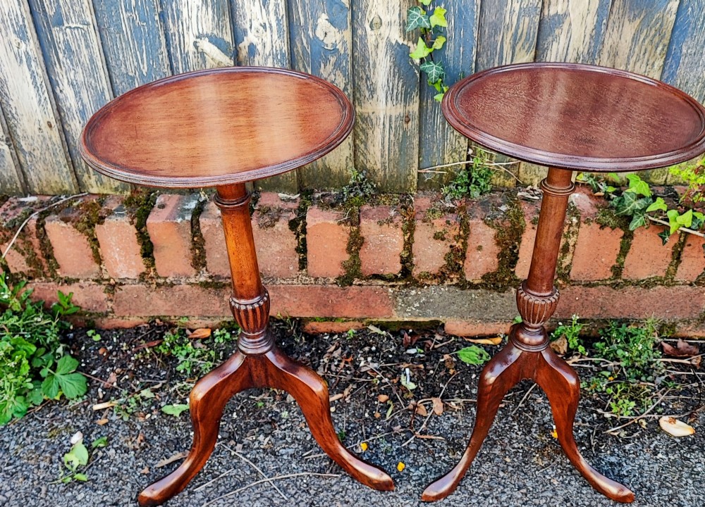 A matched pair of mahogany wine tables with circular dished tops, reeded turned stems, and cabriole tripod legs. View II