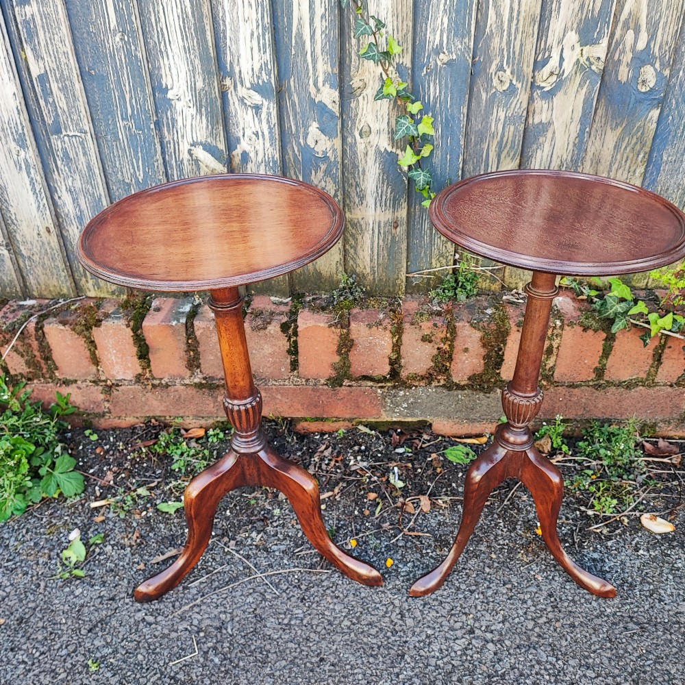 A matched pair of mahogany wine tables with circular dished tops, reeded turned stems, and cabriole tripod legs. View III