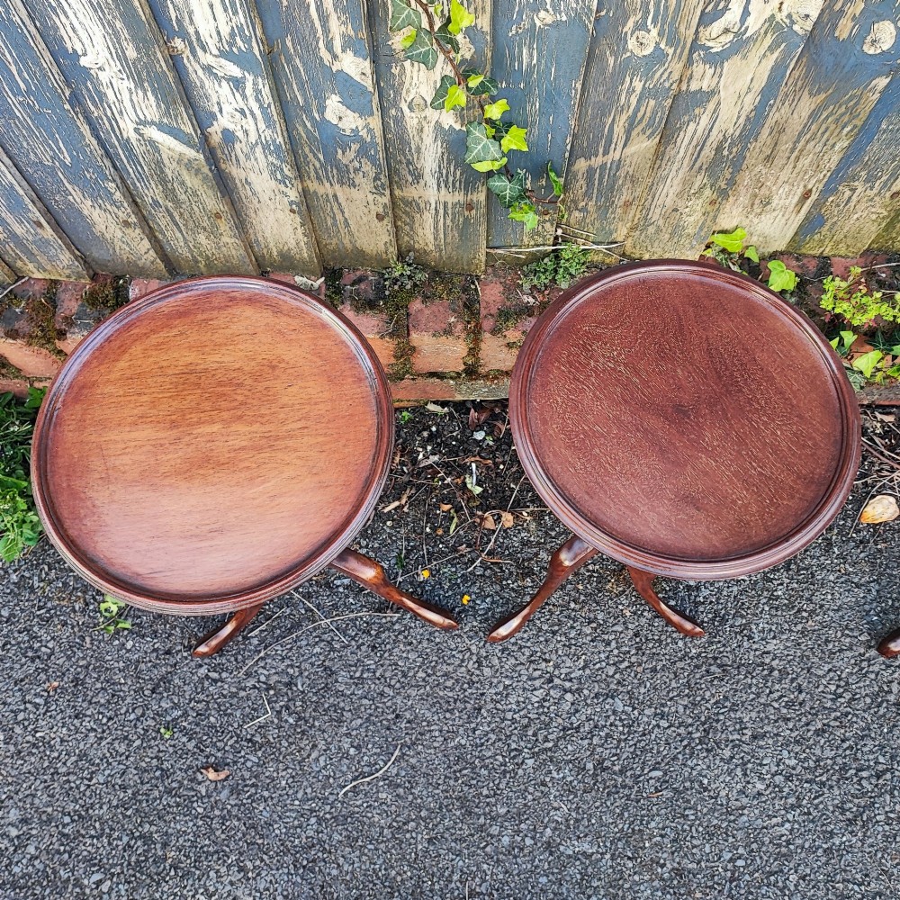 A matched pair of mahogany wine tables with circular dished tops, reeded turned stems, and cabriole tripod legs. View IV