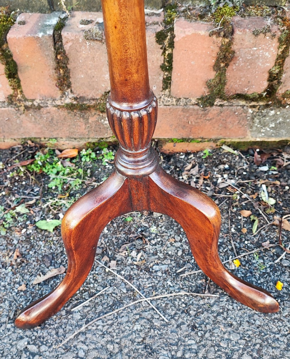 A matched pair of mahogany wine tables with circular dished tops, reeded turned stems, and cabriole tripod legs. View VII