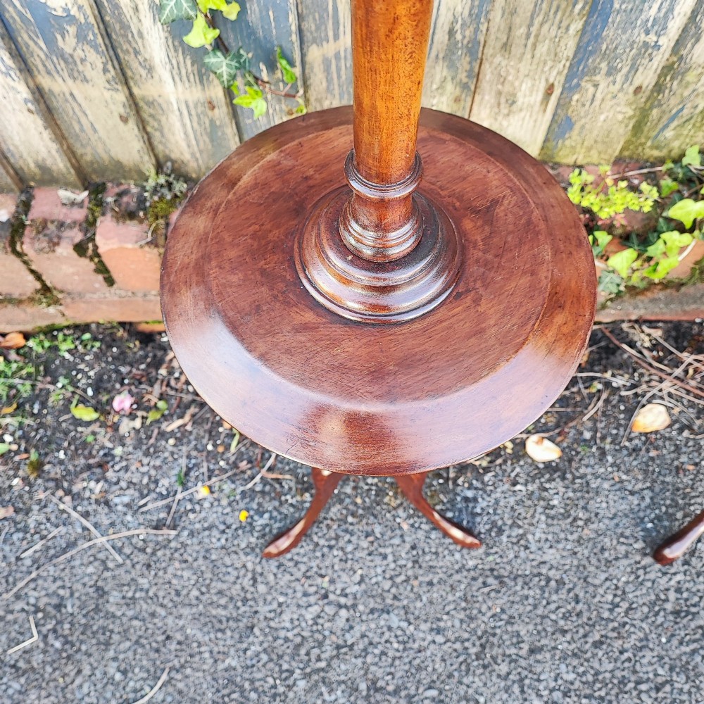 A matched pair of mahogany wine tables with circular dished tops, reeded turned stems, and cabriole tripod legs. View VIII