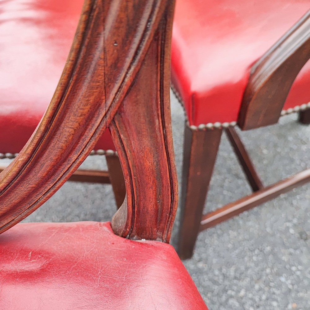 A set of eight mahogany Georgian-style dining chairs featuring carved wheat sheaf shield backs and red leather seats. View III
