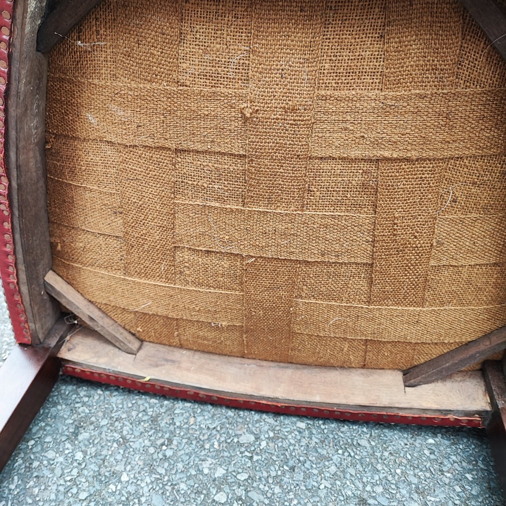 A set of eight mahogany Georgian-style dining chairs featuring carved wheat sheaf shield backs and red leather seats. View IX