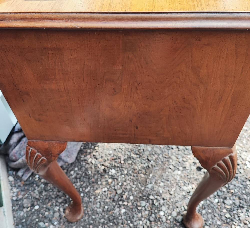 An antique burr walnut writing table featuring five drawers, brass handles, and carved cabriole legs. View VIII