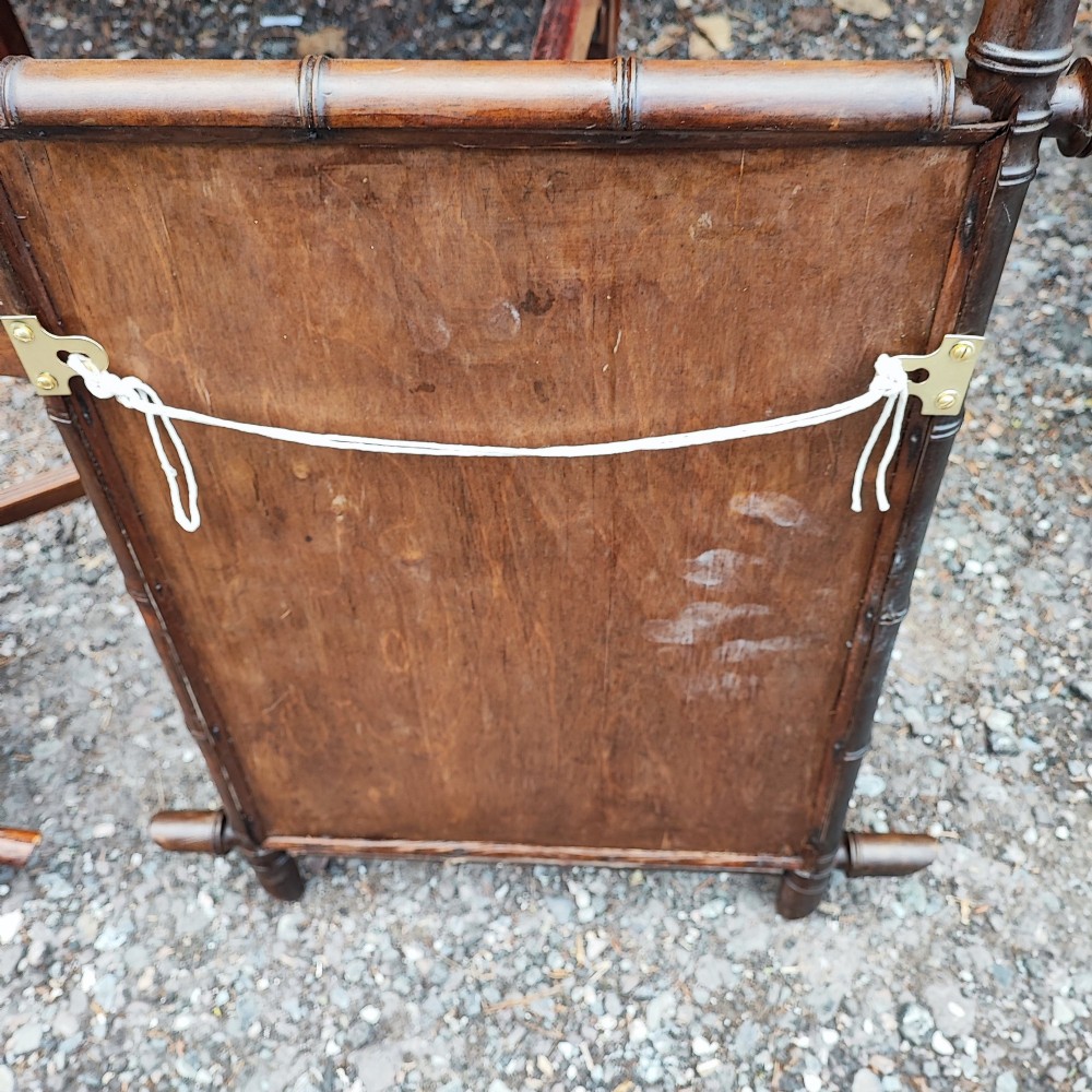 An antique French faux bamboo wall mirror featuring a rectangular warm brown wooden frame carved to imitate bamboo stalks with crossed joinery. View III