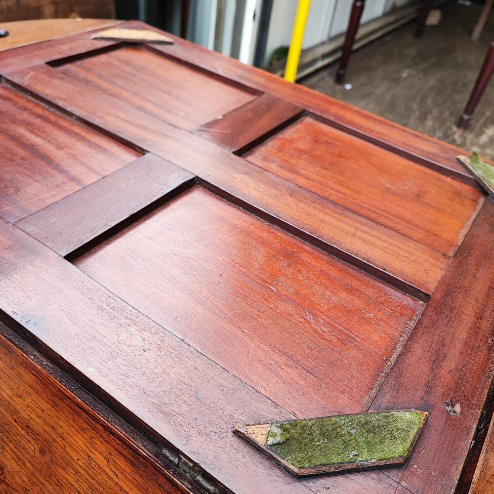 An antique mahogany campaign tray table featuring four hinged drop-down gallery sides with cutout carry handles and brass fittings, supported on a matching wooden stand. View II