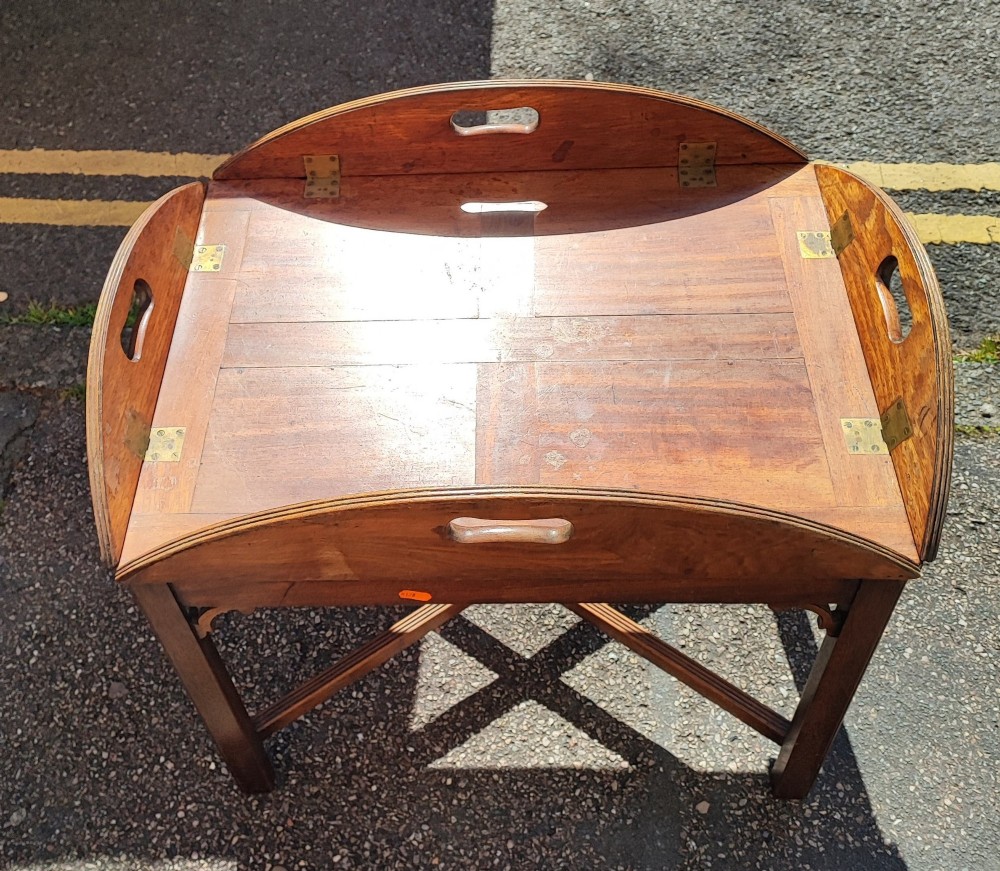 An antique mahogany campaign tray table featuring four hinged drop-down gallery sides with cutout carry handles and brass fittings, supported on a matching wooden stand. View VII